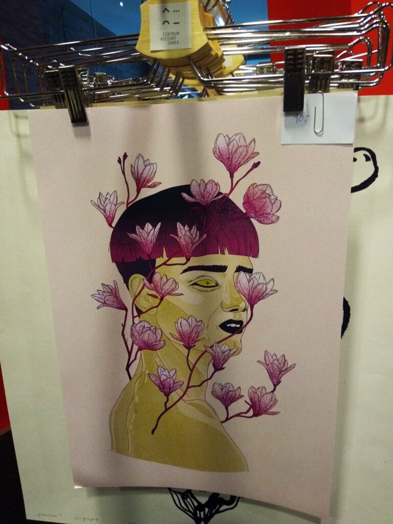 Grafika – twarz kobiety opleciona liliami.